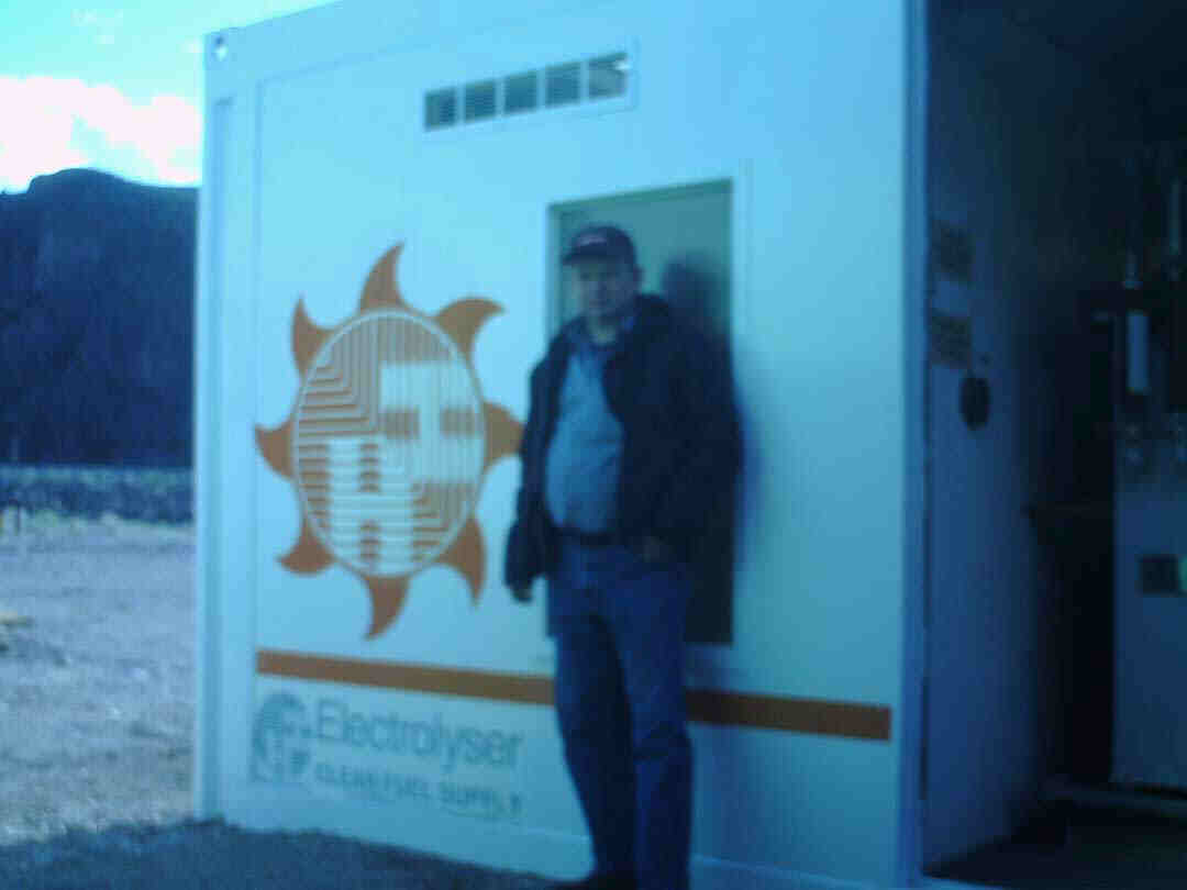 Dr. Bob stands next to the control center of the massive 8 cell hydrogen electolyzer.