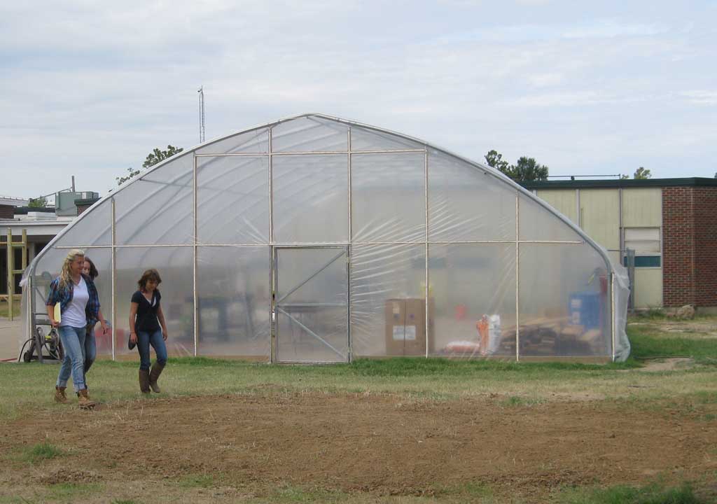 Jill Zartman and student volunteers walk past the Harrisburg Middle School greenhouse.  The greenhouse built by the Delta Garden Study and FoodCorps will house winter crops and student agricultural experiments.
